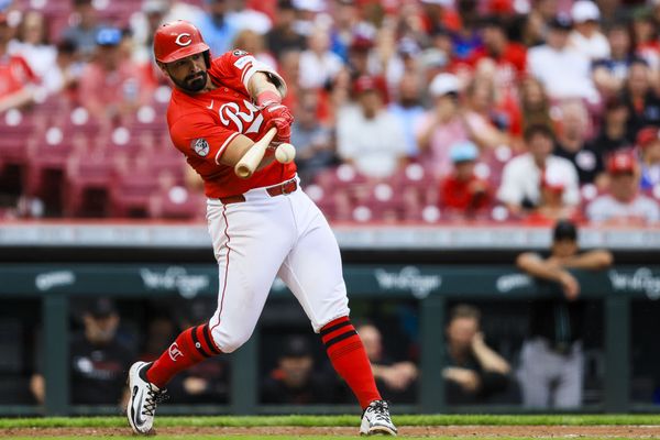 Jun 7, 2025; Cincinnati, Ohio, USA; Cincinnati Reds third baseman Christian Encarnacion-Strand (33) hits a single in the eighth inning against the Arizona Diamondbacks at Great American Ball Park. Mandatory Credit: Katie Stratman-Imagn Images