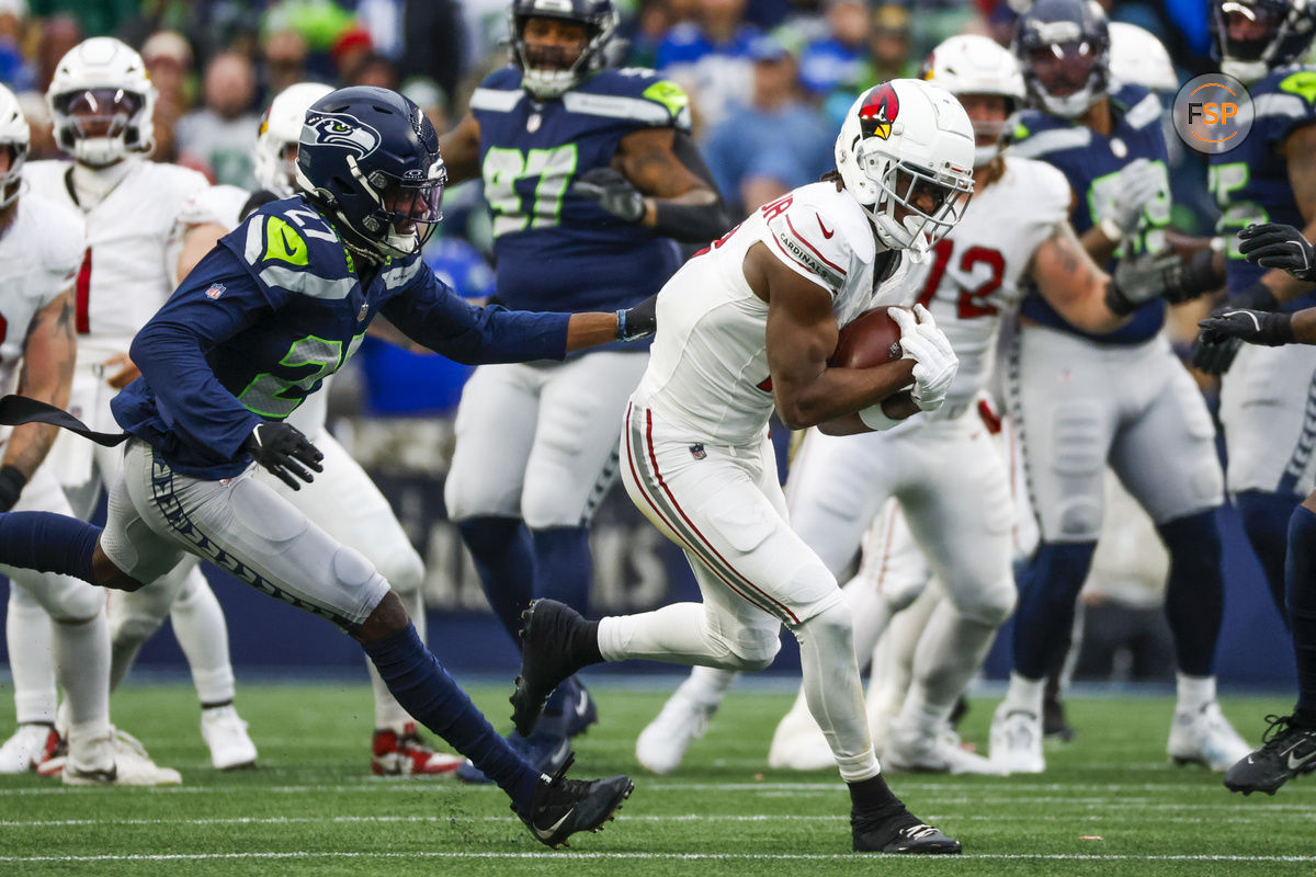 Nov 24, 2024; Seattle, Washington, USA; Arizona Cardinals wide receiver Marvin Harrison Jr. (18) catches a pass against Seattle Seahawks cornerback Riq Woolen (27) during the third quarter at Lumen Field. Credit: Joe Nicholson-Imagn Images