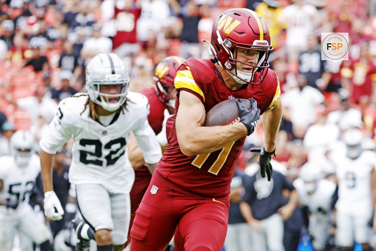 Sep 21, 2025; Landover, Maryland, USA; Washington Commanders wide receiver Luke McCaffrey (11) runs for a touchdown during the second half against the Las Vegas Raiders at Northwest Stadium. Credit: Amber Searls-Imagn Images