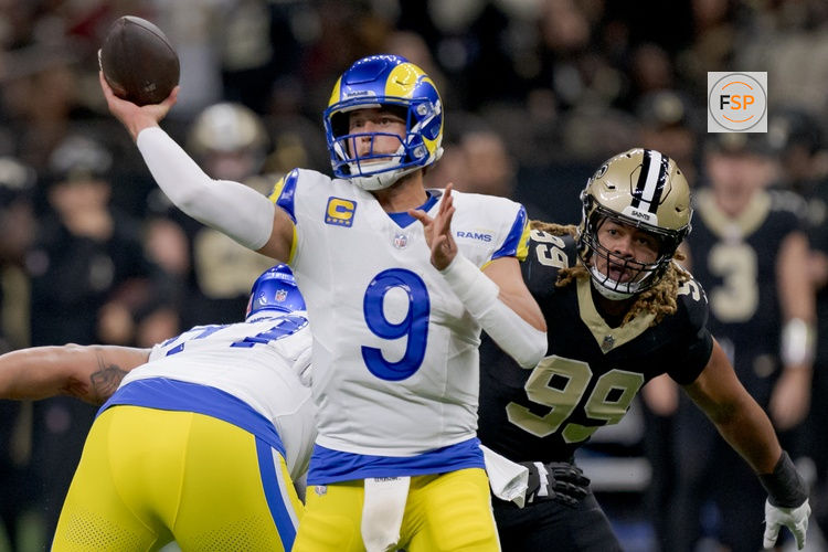 Dec 1, 2024; New Orleans, Louisiana, USA; Los Angeles Rams quarterback Matthew Stafford (9) throws against New Orleans Saints defensive end Chase Young (99) during the first half at Caesars Superdome. Credit: Matthew Hinton-Imagn Images