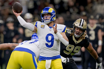 Dec 1, 2024; New Orleans, Louisiana, USA; Los Angeles Rams quarterback Matthew Stafford (9) throws against New Orleans Saints defensive end Chase Young (99) during the first half at Caesars Superdome. Mandatory Credit: Matthew Hinton-Imagn Images