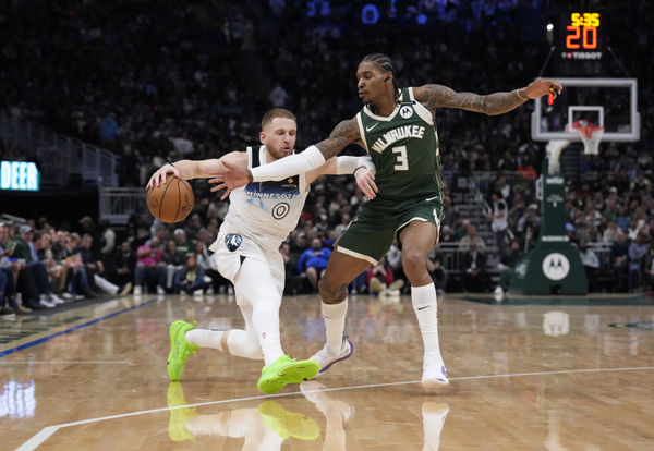 Apr 8, 2025; Milwaukee, Wisconsin, USA;  Minnesota Timberwolves guard Donte DiVincenzo (0) drives against Milwaukee Bucks guard Kevin Porter Jr. (3) in the first half at Fiserv Forum. Mandatory Credit: Michael McLoone-Imagn Images