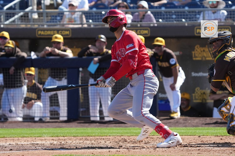 Feb 25, 2025; Peoria, Arizona, USA; Los Angeles Angels outfielder Matthew Lugo (15) hits a single against the San Diego Padres during the third inning at Peoria Sports Complex. Credit: Rick Scuteri-Imagn Images