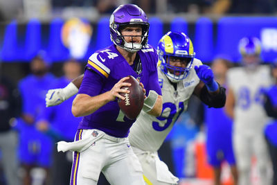 Oct 24, 2024; Inglewood, California, USA; Minnesota Vikings quarterback Sam Darnold (14) runs the ball ahead of Los Angeles Rams defensive tackle Kobie Turner (91) during the second half at SoFi Stadium. Mandatory Credit: Gary A. Vasquez-Imagn Images