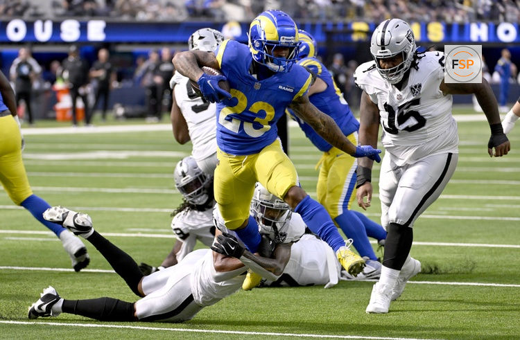 Oct 20, 2024; Inglewood, California, USA; Los Angeles Rams running back Kyren Williams (23) breaks away from Las Vegas Raiders safety Isaiah Pola-Mao (below left) to out run quarterback Gardner Minshew (15) for a touchdown in the first half at SoFi Stadium. Credit: Alex Gallardo-Imagn Images
