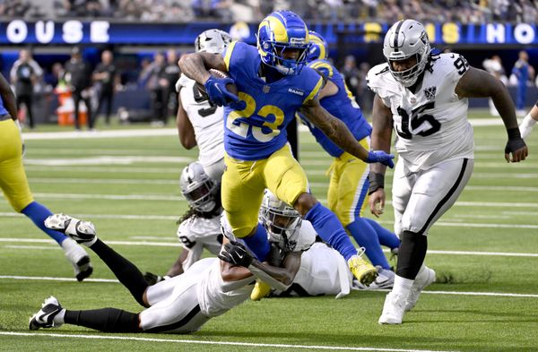 Oct 20, 2024; Inglewood, California, USA; Los Angeles Rams running back Kyren Williams (23) breaks away from Las Vegas Raiders safety Isaiah Pola-Mao (below left) to out run quarterback Gardner Minshew (15) for a touchdown in the first half at SoFi Stadium. Mandatory Credit: Alex Gallardo-Imagn Images