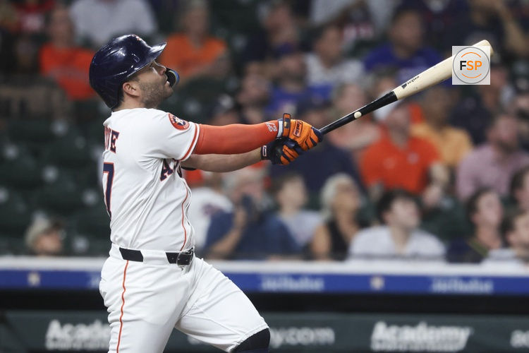 Sep 16, 2025; Houston, Texas, USA; Houston Astros second baseman Jose Altuve (27) drives in a run with a sacrifice fly during the first inning against the Texas Rangers at Daikin Park. Credit: Troy Taormina-Imagn Images