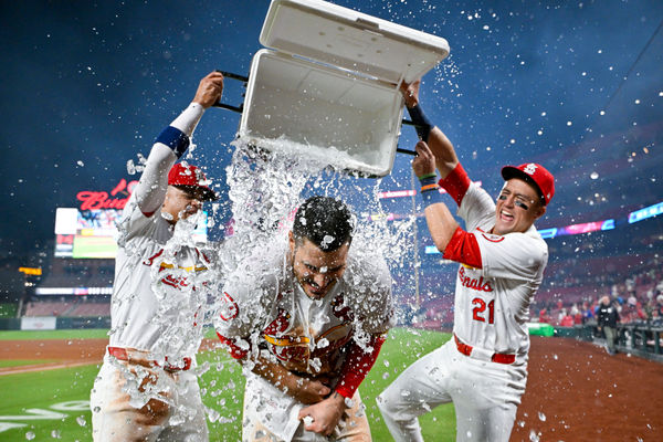 Aug 21, 2024; St. Louis, Missouri, USA;  St. Louis Cardinals third baseman Nolan Arenado (28) is doused with water by shortstop Masyn Winn (0) and center fielder Lars Nootbaar (21) after hitting a walk-off grand slam against the Milwaukee Brewers during the tenth inning at Busch Stadium. Mandatory Credit: Jeff Curry-USA TODAY Sports