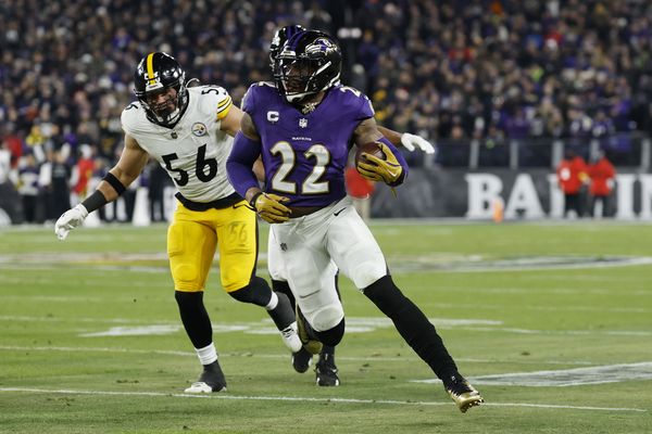 Jan 11, 2025; Baltimore, Maryland, USA; Baltimore Ravens running back Derrick Henry (22) runs against Pittsburgh Steelers linebacker Alex Highsmith (56) in the second quarter in an AFC wild card game at M&T Bank Stadium. Mandatory Credit: Geoff Burke-Imagn Images