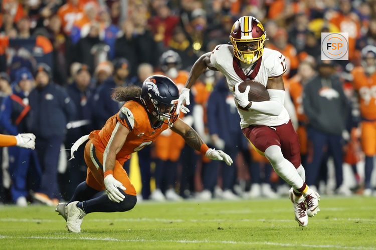 Nov 30, 2025; Landover, Maryland, USA; Washington Commanders wide receiver Terry McLaurin (17) runs with the ball after making a catch as Denver Broncos safety Talanoa Hufanga (9) defends in the second quarter at Northwest Stadium. Credit: Geoff Burke-Imagn Images