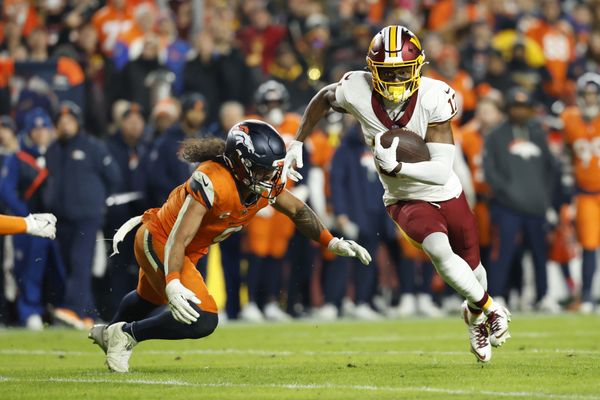 Nov 30, 2025; Landover, Maryland, USA; Washington Commanders wide receiver Terry McLaurin (17) runs with the ball after making a catch as Denver Broncos safety Talanoa Hufanga (9) defends in the second quarter at Northwest Stadium. Mandatory Credit: Geoff Burke-Imagn Images