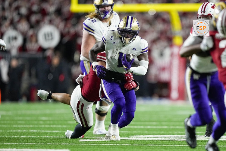 Nov 8, 2025; Madison, Wisconsin, USA;  Washington Huskies running back Jonah Coleman (1) rushes with the football against Wisconsin Badgers linebacker Mason Posa (8) during the second quarter at Camp Randall Stadium. Credit: Jeff Hanisch-Imagn Images