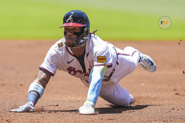 May 20, 2024; Cumberland, Georgia, USA; Atlanta Braves right fielder Ronald Acuna Jr (13) slides into third base against the San Diego Padres during the first inning at Truist Park. Credit: Dale Zanine-USA TODAY Sports