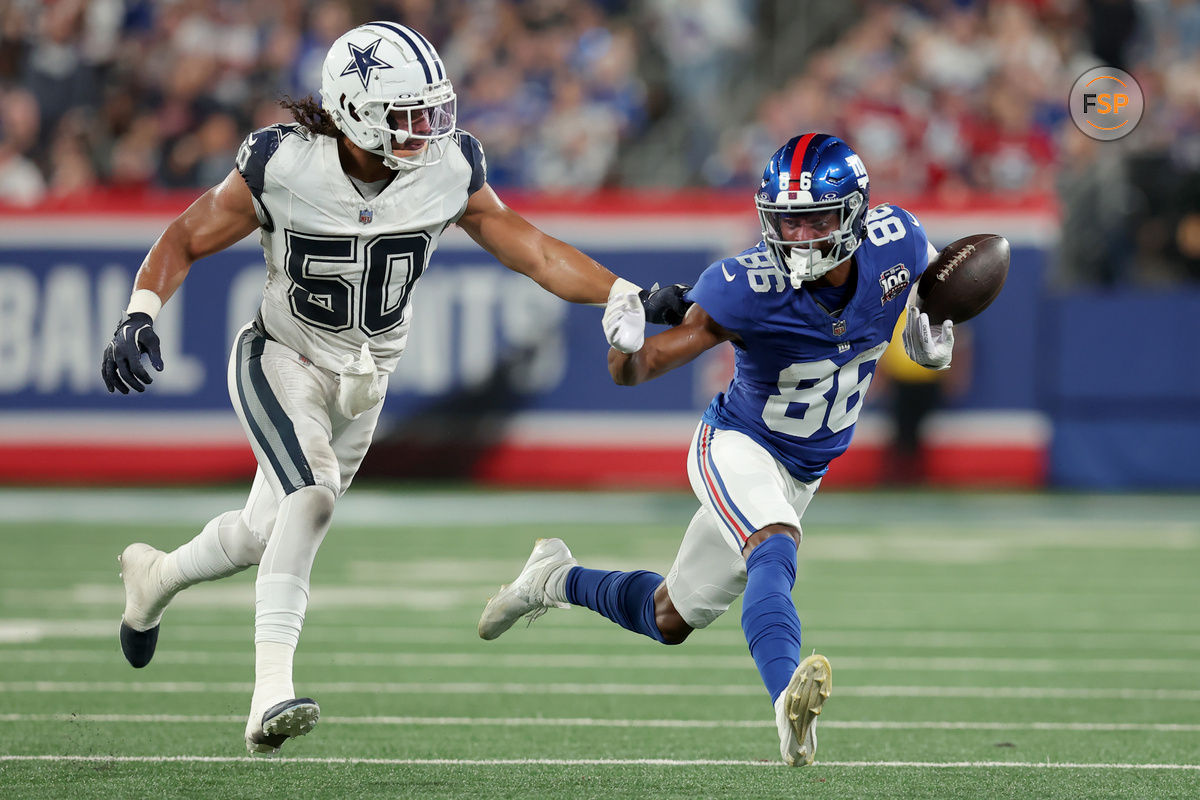 Sep 26, 2024; East Rutherford, New Jersey, USA; New York Giants wide receiver Darius Slayton (86) bobbles the ball as he runs against Dallas Cowboys linebacker Eric Kendricks (50) during the second quarter at MetLife Stadium. Credit: Brad Penner-Imagn Images