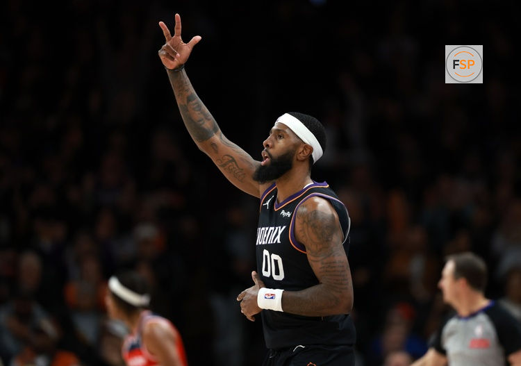 Jan 11, 2026; Phoenix, Arizona, USA; Phoenix Suns forward Royce O'Neale (00) celebrates a three point shot against the Washington Wizards in the second half at Mortgage Matchup Center. Credit: Mark J. Rebilas-Imagn Images