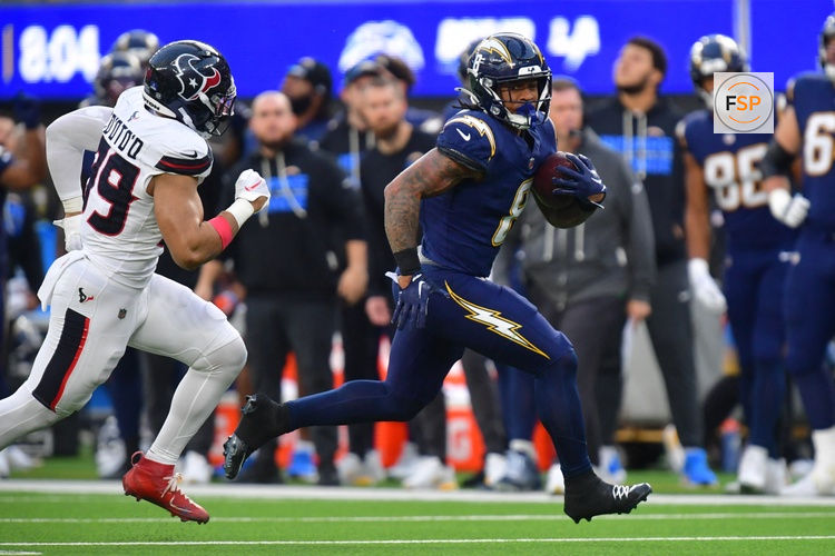 Dec 27, 2025; Inglewood, California, USA;  Los Angeles Chargers running back Omarion Hampton (8) runs with the ball as Houston Texans linebacker Henry To'Oto'O (39) defends during the first half at SoFi Stadium. Credit: Gary A. Vasquez-Imagn Images