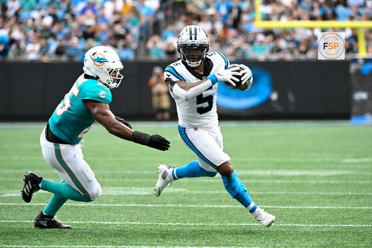 Oct 5, 2025; Charlotte, North Carolina, USA; Carolina Panthers running back Rico Dowdle (5) with the ball as Miami Dolphins linebacker Tyrel Dodson (25) defends in the second quarter at Bank of America Stadium. Credit: Bob Donnan-Imagn Images