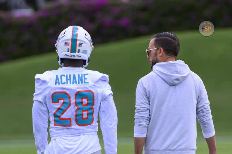 MIAMI GARDENS, FL - MAY 12: Miami Dolphins running back Devon Achane (28) and Miami Dolphins head coach Mike McDaniel talk on the field during the rookie minicamp at the Baptist Health Training Complex on May 12, 2023 in Miami Gardens, Florida. (Photo by Doug Murray/Icon Sportswire)