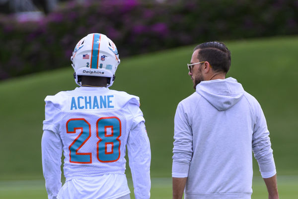 MIAMI GARDENS, FL - MAY 12: Miami Dolphins running back Devon Achane (28) and Miami Dolphins head coach Mike McDaniel talk on the field during the rookie minicamp at the Baptist Health Training Complex on May 12, 2023 in Miami Gardens, Florida. (Photo by Doug Murray/Icon Sportswire)