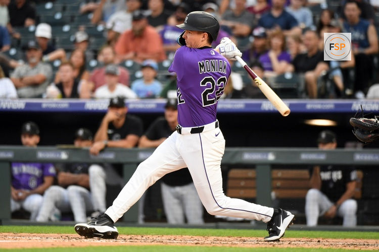 Jul 1, 2026; Denver, Colorado, USA; Colorado Rockies outfielder Mickey Moniak (22) hits a triple in the fifth inning against the Miami Marlins at Coors Field. Credit: Christopher Hanewinckel-Imagn Images