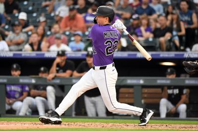 Jul 1, 2026; Denver, Colorado, USA; Colorado Rockies outfielder Mickey Moniak (22) hits a triple in the fifth inning against the Miami Marlins at Coors Field. Mandatory Credit: Christopher Hanewinckel-Imagn Images