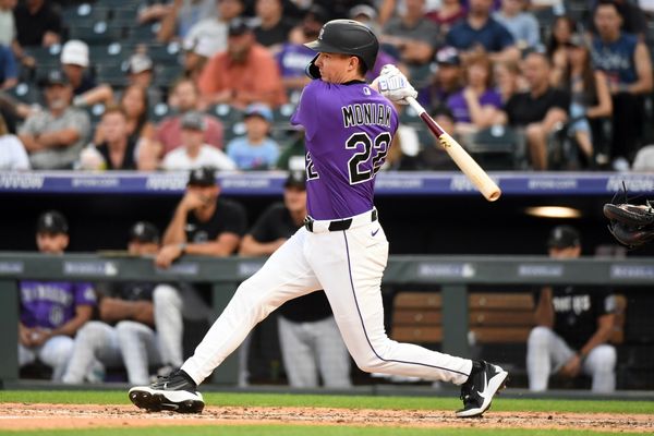 Jul 1, 2026; Denver, Colorado, USA; Colorado Rockies outfielder Mickey Moniak (22) hits a triple in the fifth inning against the Miami Marlins at Coors Field. Mandatory Credit: Christopher Hanewinckel-Imagn Images