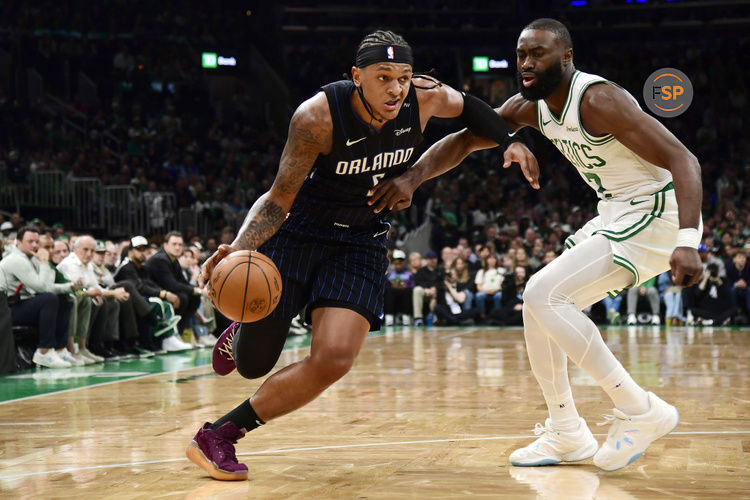 Apr 20, 2025; Boston, Massachusetts, USA;  Orlando Magic forward Paolo Banchero (5) controls the ball while Boston Celtics guard Jaylen Brown (7) defends during the first half at TD Garden. Credit: Bob DeChiara-Imagn Images