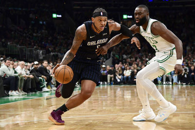 Apr 20, 2025; Boston, Massachusetts, USA;  Orlando Magic forward Paolo Banchero (5) controls the ball while Boston Celtics guard Jaylen Brown (7) defends during the first half at TD Garden. Mandatory Credit: Bob DeChiara-Imagn Images