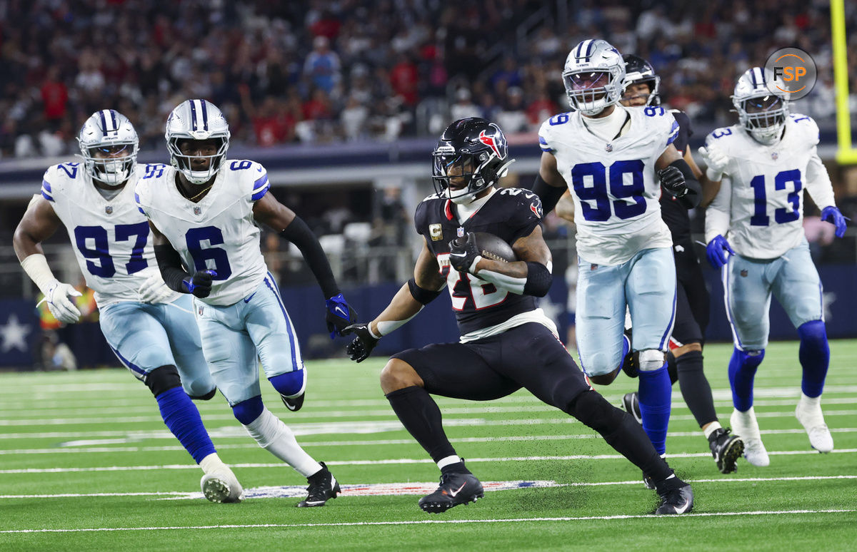 Nov 18, 2024; Arlington, Texas, USA; Houston Texans running back Joe Mixon (28) runs with the ball as Dallas Cowboys safety Donovan Wilson (6) and Dallas Cowboys defensive end Chauncey Golston (99) chase him during the second half at AT&T Stadium. Credit: Kevin Jairaj-Imagn Images