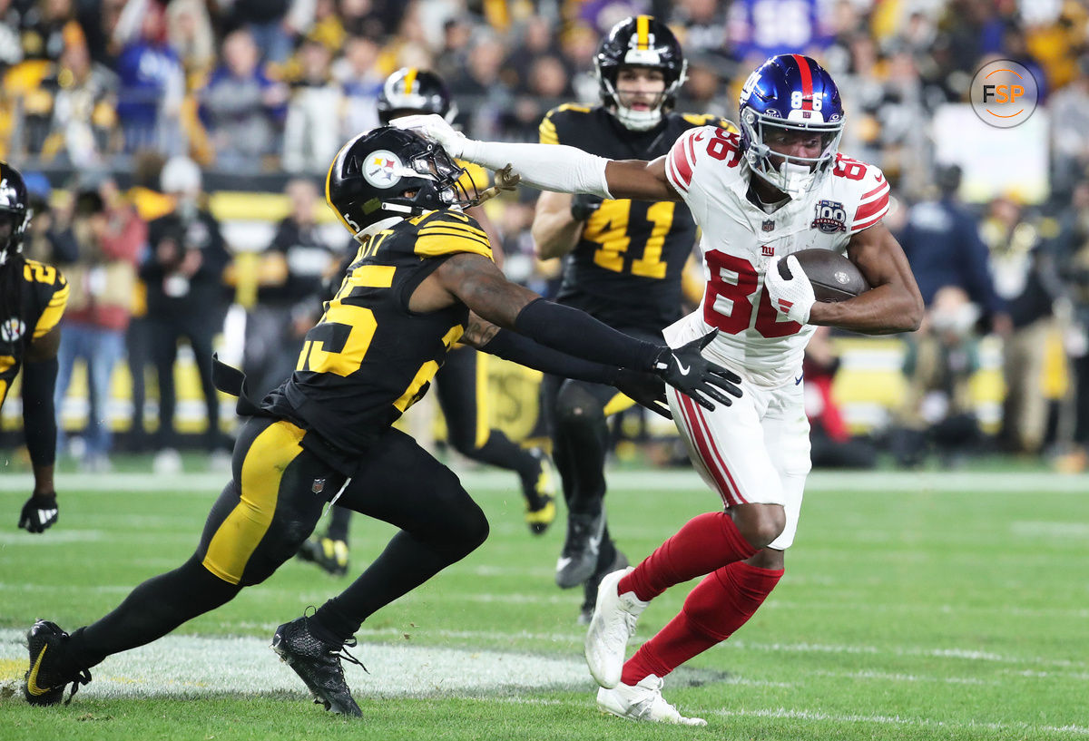 Oct 28, 2024; Pittsburgh, Pennsylvania, USA; New York Giants wide receiver Darius Slayton (86) runs after a catch as Pittsburgh Steelers safety DeShon Elliott (25) defends during the second quarter at Acrisure Stadium. Credit: Charles LeClaire-Imagn Images