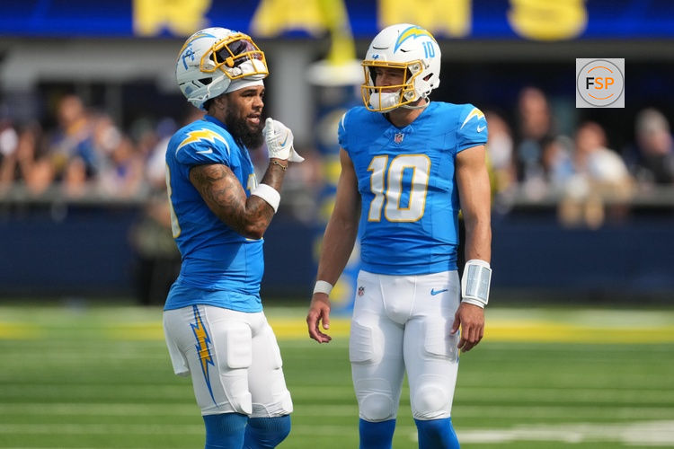 Aug 16, 2025; Inglewood, California, USA; Los Angeles Chargers quarterback Justin Herbert (10) talks with wide receiver Keenan Allen (13) against the Los Angeles Rams in the first half at SoFi Stadium. Credit: Kirby Lee-Imagn Images