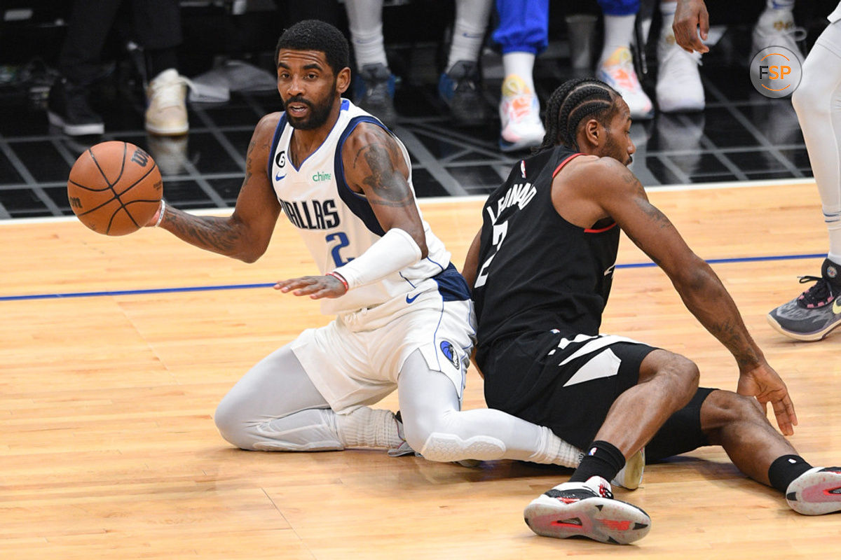 LOS ANGELES, CA - FEBRUARY 08: Dallas Mavericks Guard Kyrie Irving (2) makes a pass from his knees after he got tangled up with Los Angeles Clippers Forward Kawhi Leonard (2) during a NBA game between the Dallas Mavericks and the Los Angeles Clippers on February 8, 2023 at Crypto.com Arena in Los Angeles, CA. (Photo by Brian Rothmuller/Icon Sportswire)