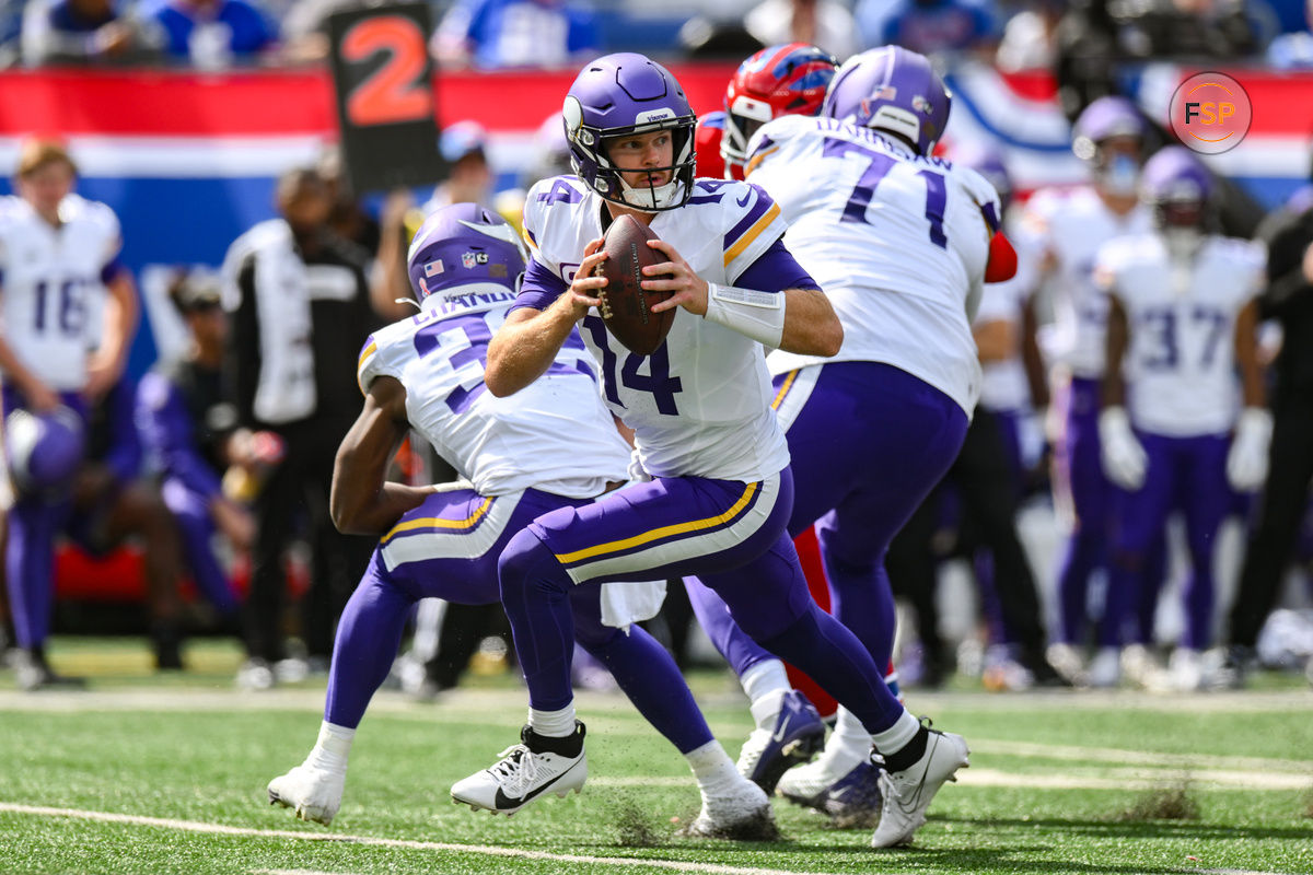 Sep 8, 2024; East Rutherford, New Jersey, USA; Minnesota Vikings quarterback Sam Darnold (14) rolls out to pass against the New York Giants during the second half at MetLife Stadium. Credit: John Jones-Imagn Images