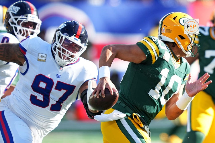 Nov 16, 2025; East Rutherford, New Jersey, USA; Green Bay Packers quarterback Jordan Love (10) scrambles away from New York Giants defensive tackle Dexter Lawrence II (97) during the first quarter at MetLife Stadium. Credit: Robert Deutsch-Imagn Images