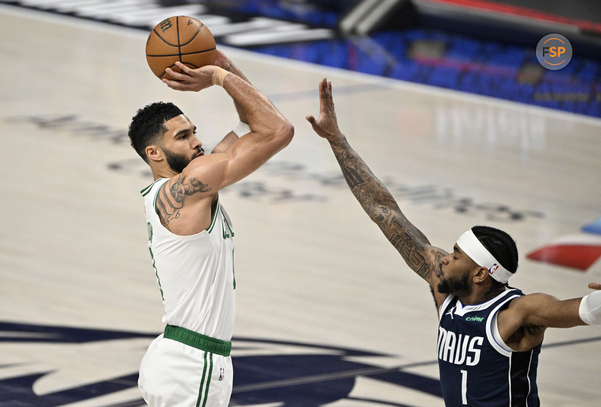 Jun 12, 2024; Dallas, Texas, USA; Boston Celtics forward Jayson Tatum (0) shoots against Dallas Mavericks guard Jaden Hardy (1) during the first quarter in game three of the 2024 NBA Finals at American Airlines Center. Credit: Jerome Miron-USA TODAY Sports