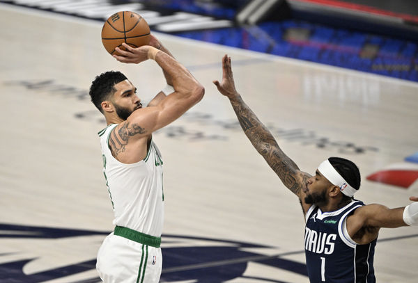 Jun 12, 2024; Dallas, Texas, USA; Boston Celtics forward Jayson Tatum (0) shoots against Dallas Mavericks guard Jaden Hardy (1) during the first quarter in game three of the 2024 NBA Finals at American Airlines Center. Mandatory Credit: Jerome Miron-USA TODAY Sports