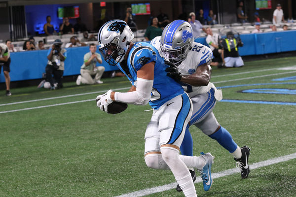 CHARLOTTE, NC - AUGUST 25: Carolina Panthers wide receiver Adam Thielen (19) catches a touchdown pass with Detroit Lions corner back Will Harris (25) defending on the play during a preseason NFL football game between the Detroit Lions and the Carolina Panthers on September 25, 2023, at Bank of America Stadium in Charlotte, N.C. (Photo by John Byrum/Icon Sportswire)