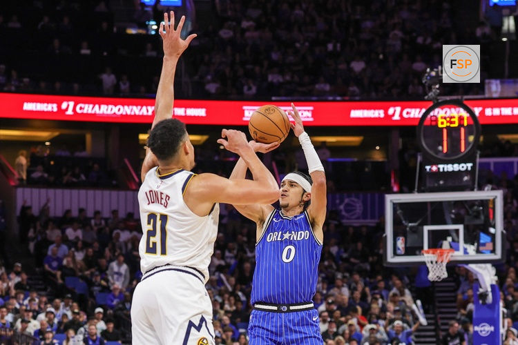 Dec 27, 2025; Orlando, Florida, USA; Orlando Magic guard Anthony Black (0) shoots against Denver Nuggets forward Spencer Jones (21) during the first quarter at Kia Center. Credit: Mike Watters-Imagn Images