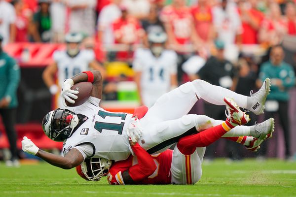 Sep 14, 2025; Kansas City, Missouri, USA; Kansas City Chiefs defensive tackle Omarr Norman-Lott (55) tackles Philadelphia Eagles wide receiver A.J. Brown (11) during the second quarter of the game at GEHA Field at Arrowhead Stadium. Mandatory Credit: Jay Biggerstaff-Imagn Images
