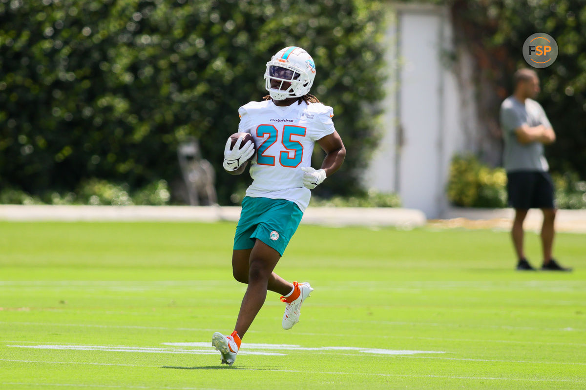 Jun 4, 2024; Miami Gardens, FL, USA; Miami Dolphins running back Jaylen Wright (25) runs with the football during mandatory minicamp at Baptist Health Training Complex. Credit: Sam Navarro-USA TODAY Sports