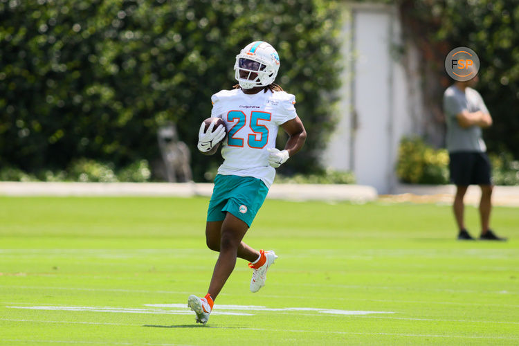 Jun 4, 2024; Miami Gardens, FL, USA; Miami Dolphins running back Jaylen Wright (25) runs with the football during mandatory minicamp at Baptist Health Training Complex. Credit: Sam Navarro-USA TODAY Sports