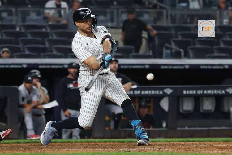 Aug 13, 2025; Bronx, New York, USA; New York Yankees right fielder Giancarlo Stanton (27) singles during the ninth inning against the Minnesota Twins at Yankee Stadium. Credit: Vincent Carchietta-Imagn Images