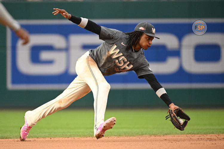 Aug 31, 2024; Washington, District of Columbia, USA; Washington Nationals shortstop CJ Abrams (5) fields a ground ball against the Chicago Cubs during the eighth inning at Nationals Park. Credit: Rafael Suanes-USA TODAY Sports