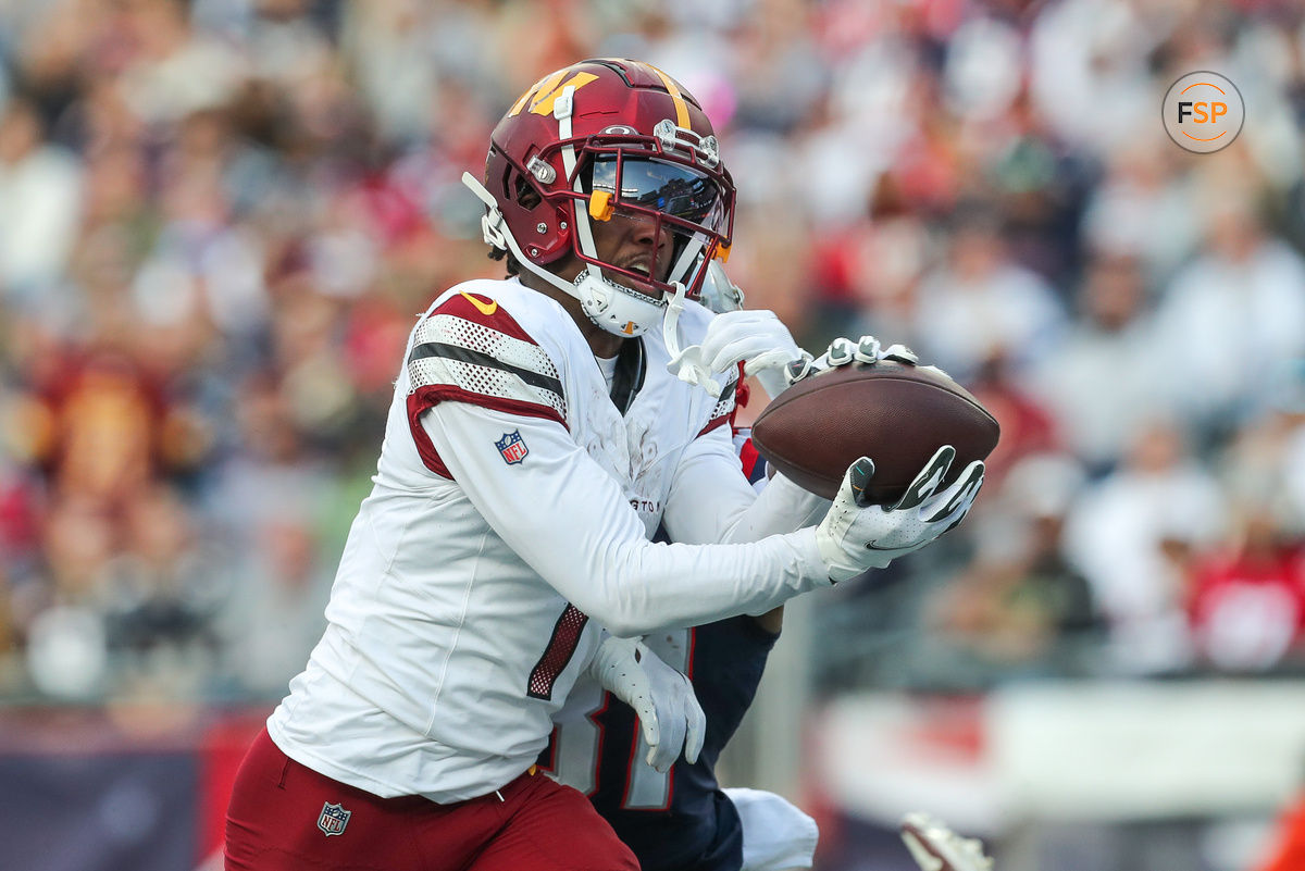 Nov 5, 2023; Foxborough, Massachusetts, USA; Washington Commanders receiver Jahan Dotson (1) catches a pass for a touchdown during the second half against the New England Patriots at Gillette Stadium. Credit: Paul Rutherford-USA TODAY Sports