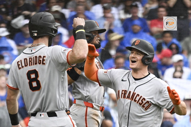 Jun 5, 2026; Chicago, Illinois, USA;  San Francisco Giants third baseman Matt Chapman (26), right, high fives San Francisco Giants second baseman Luis Arraez (1) and designated hitter Bryce Eldridge (8) after he hits a grand slam against the Chicago Cubs during the fourth inning at Wrigley Field. Credit: Matt Marton-Imagn Images