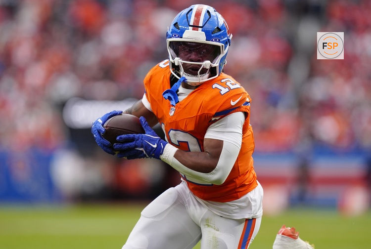 Oct 26, 2025; Denver, Colorado, USA; Denver Broncos running back RJ Harvey (12) runs against the Dallas Cowboys in the second half at Empower Field at Mile High. Credit: Ron Chenoy-Imagn Images