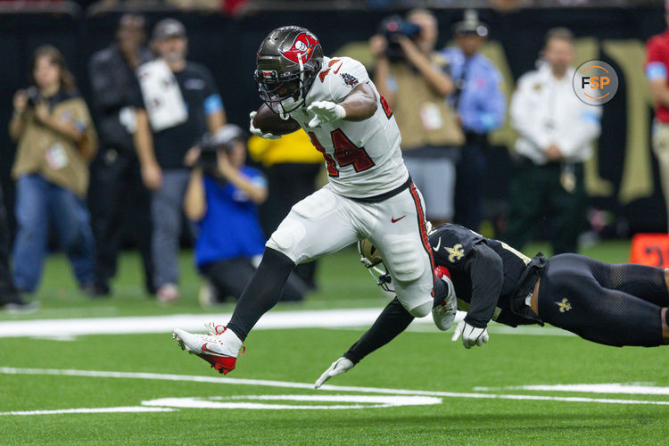 Oct 13, 2024; New Orleans, Louisiana, USA;  Tampa Bay Buccaneers running back Sean Tucker (44) runs away from the tackle of New Orleans Saints safety Johnathan Abram (24) during the first half at Caesars Superdome. Credit: Stephen Lew-Imagn Images