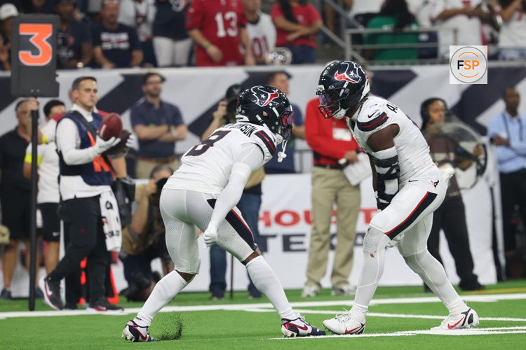 Sep 15, 2025; Houston, Texas, USA; Houston Texans safety C.J. Gardner-Johnson (8) and Houston Texans linebacker Azeez Al-Shaair (0) celebrate after making a tackle during the second quarter against the Tampa Bay Buccaneers at NRG Stadium. Credit: Thomas Shea-Imagn Images