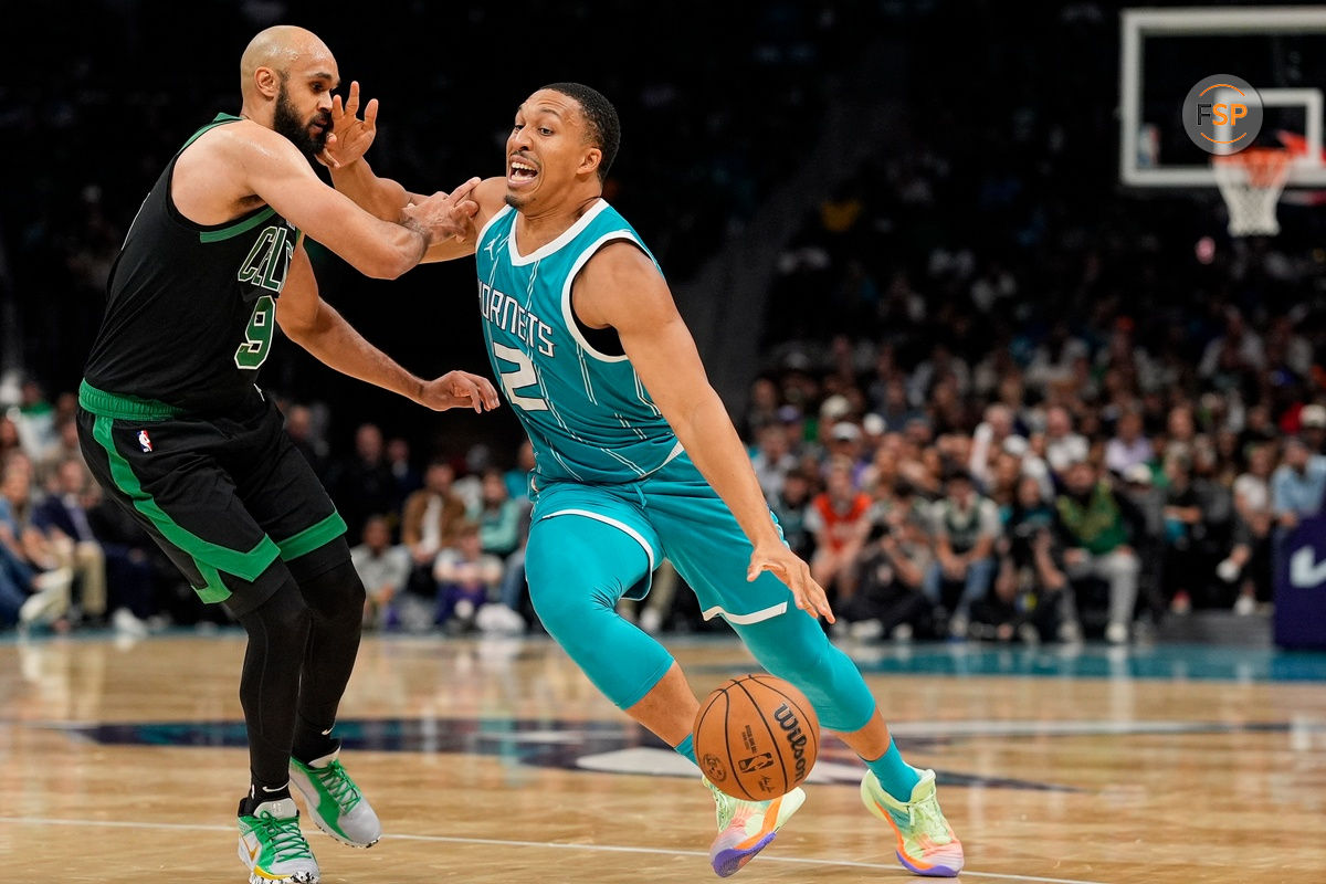 Nov 1, 2024; Charlotte, North Carolina, USA; Charlotte Hornets forward Grant Williams (2) drives to the basket against Boston Celtics guard Derrick White (9) during the second half at the Spectrum Center. Credit: Jim Dedmon-Imagn Images