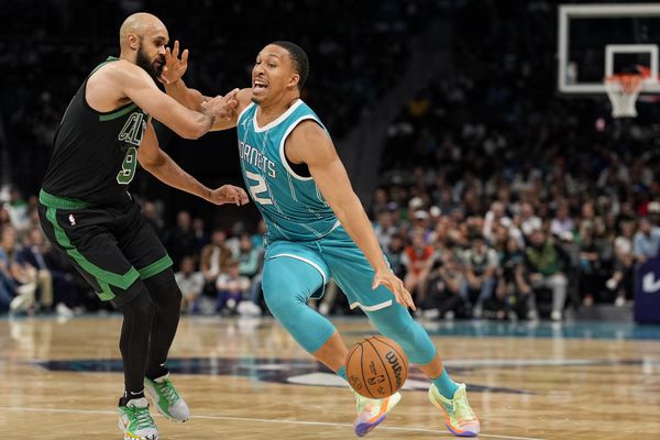 Nov 1, 2024; Charlotte, North Carolina, USA; Charlotte Hornets forward Grant Williams (2) drives to the basket against Boston Celtics guard Derrick White (9) during the second half at the Spectrum Center. Mandatory Credit: Jim Dedmon-Imagn Images